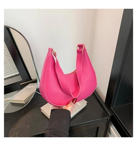 Detail view of the rose pink crescent hobo bag made of high-quality textured PU leather
