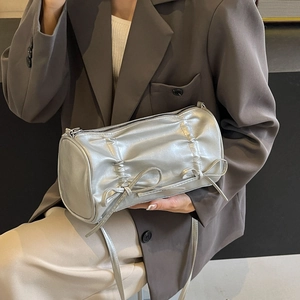 Silver metallic pleated cylinder bag with bow details and sleek shoulder strap