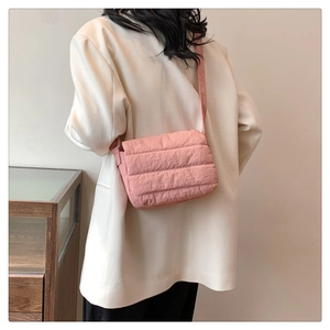 Detailed view of pink quilted puffer tote bag on a model for casual daily styling