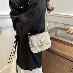 Chic woven shoulder bag with floral embroidery and golden horseshoe lock detail