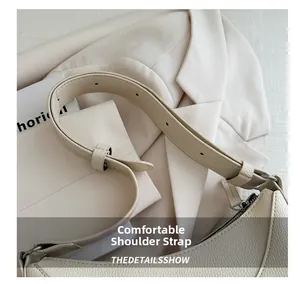 Detail of adjustable pebble leather shoulder strap with polished silver metal hardware