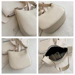 Detail view of beige hobo bag showing litchi grain leather and interior compartment