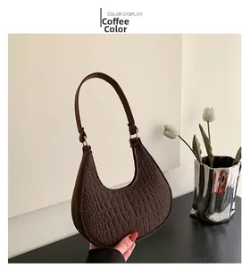 Detailed close-up of coffee brown hobo bag featuring premium crocodile texture and gold hardware