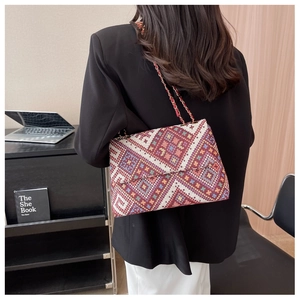 Ethnic geometric pattern flap shoulder bag with metal and red leather chain strap detail