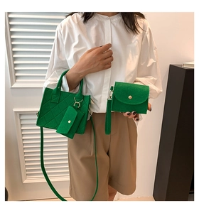Detailed view of vibrant green felt tote bag set with quilted stitching and gold hardware