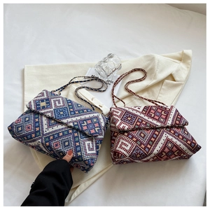 Detailed close-up of retro chain shoulder bags featuring ethnic geometric patterns