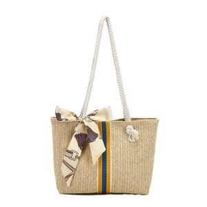 Straw beach tote with rainbow stripes, cotton rope handles, and decorative silk scarf