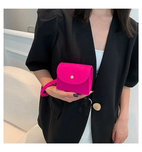 Detail of rose red felt wristlet bag with gold snap button and textured fabric