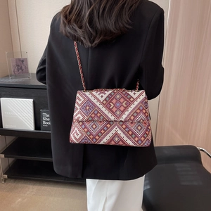 Ethnic knit tote bag with red geometric patterns and gold chain strap for women