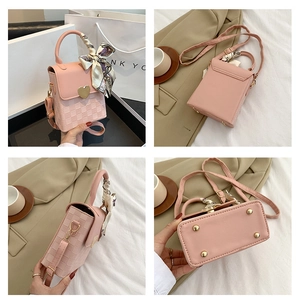Detail views of a pink chain crossbody bag with heart clasp and floral scarf handle