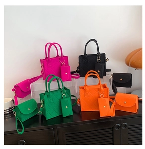 Close-up of quilted felt tote bags in rose, green, black and orange with matching mini pouches