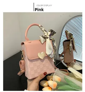 Pink chain bag with relief plaid pattern, golden heart buckle, and scarf wrap handle