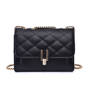 Elegant black quilted crossbody bag with gold chain strap and U-shaped metallic buckle