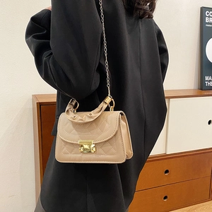 Elegant beige quilted crossbody bag with gold hardware and stylish ruched top handle