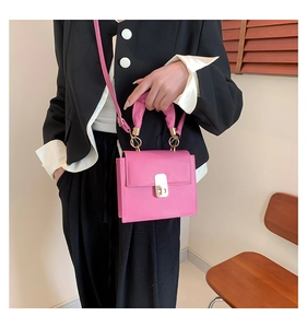 Pink PU leather square bag with pleated handle and metal buckle shown on a model