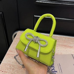 Neon green mini handbag with rhinestone bow and detachable silver chain strap