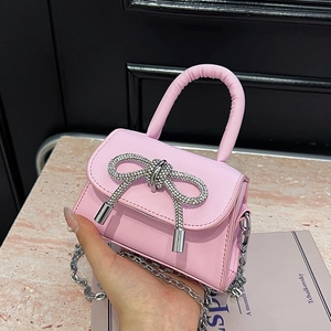 Pink mini handbag with rhinestone bow decoration and silver chain for women