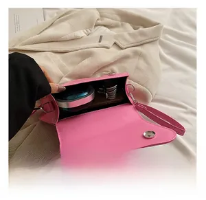 Detail view showing the spacious interior of pink bow shoulder bag with magnetic clasps