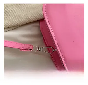 Detail of high-quality silver metal lobster clasp and pink leather strap stitching