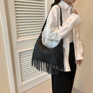 Fashionable black matte leather shoulder bag with long flowing fringes for casual wear