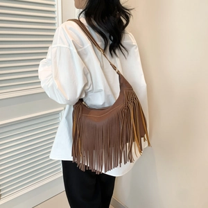 Brown leather hobo bag with bohemian fringe detail and adjustable strap for women