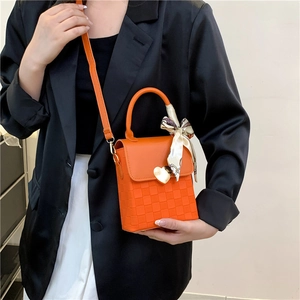 Minimalist orange chain crossbody bag with heart buckle and scarf handle