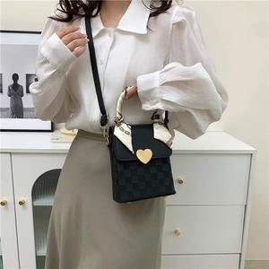 Elegant black crossbody square bag with gold heart buckle and silk scarf handle detail