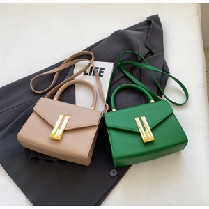 Detailed close-up of textured leather handbags with stylish gold metal locks and handles