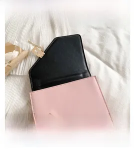 Pink rectangular matte leather flap bag with gold metal buckle and black interior