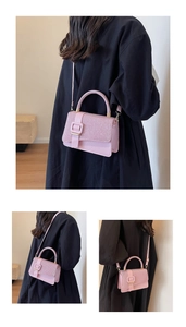 Detailed view of pink glitter PU leather handbag with sparkling finish and square buckle