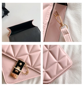 Detail view of pink quilted leather bag showing gold hardware and stitching texture