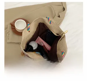 Macro view of woven tote bag interior showing large capacity and colorful tassel detail