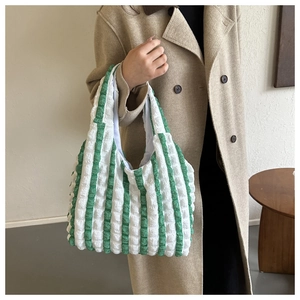 Detail of green and white striped bubble texture fabric on a casual tote bag