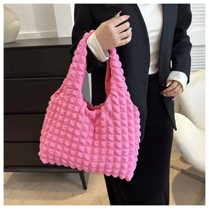 Detail of pink bubble texture fabric on a large capacity stylish tote shoulder bag