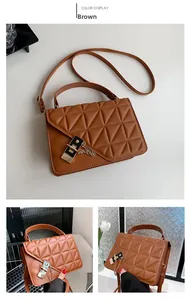 Detail view of brown quilted handbag showing triangle stitching and chain strap