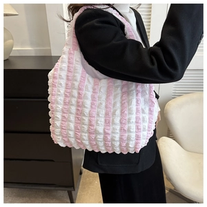 Detail of pink and white striped seersucker tote bag showing the soft pleated texture