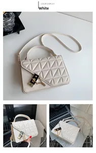 Close-up of white quilted PU leather crossbody bag with gold lock and chain detail