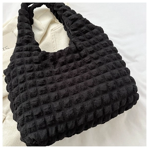 Detail of black bubble textured tote bag with puffy popcorn fabric for casual wear