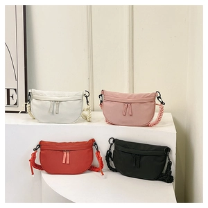 Detail of canvas saddle bags in four colors with thick woven straps and dual zippers