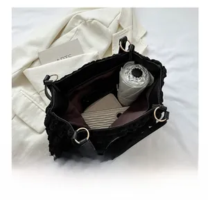 Interior view showing the large storage capacity of this black pleated tote bag for daily use