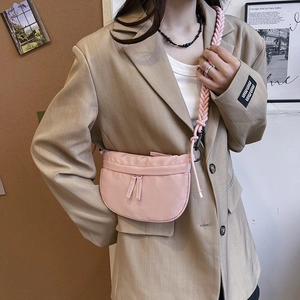 Pink crescent nylon crossbody bag with chunky braided rope strap on female model