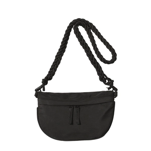 Minimalist black crescent crossbody bag with thick woven shoulder strap and dual zipper detail