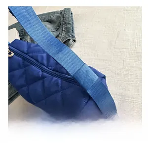 Detailed macro view of the blue quilted shoulder bag featuring premium fabric texture