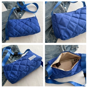 Quilted royal blue puffer bag details showing interior space and adjustable strap