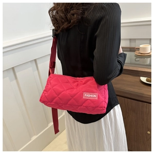 Detail of rose pink quilted nylon shoulder bag with wide strap and Fashion label