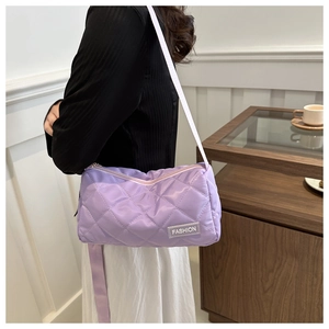 Detail view of light purple quilted tote bag with diamond texture and fashion tag