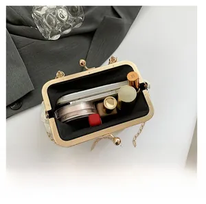 Internal view of the white beaded evening bag showing storage space for cosmetics