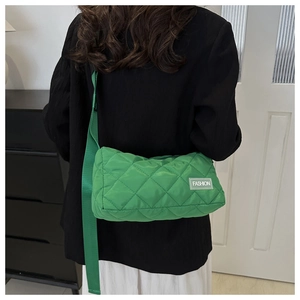 Detailed back view of a bright green quilted tote bag with a white fashion label tag