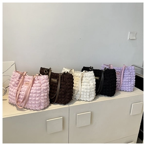 Variety of colorful popcorn fabric tote bags with fashion labels on display