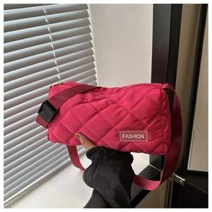 Close-up of rose pink quilted nylon tote with adjustable strap and Fashion patch